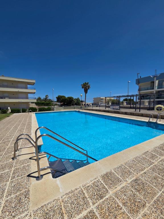 a swimming pool with blue water in a building at Entre Aguas in L'Eucaliptus