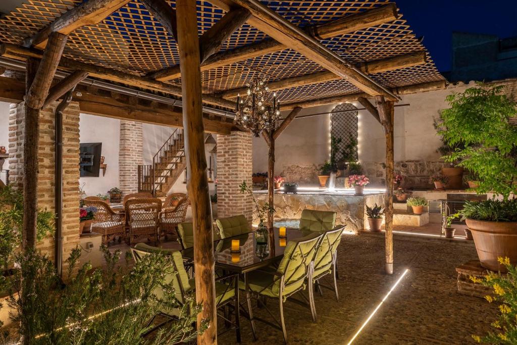 a patio with a table and chairs under a pergola at Casa Rural El Baluarte - Grupos in Caudilla
