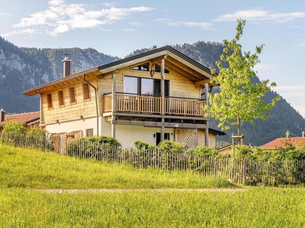 a house on a hill with a fence at Chalet Alpenzauber mit beheiztem Pool, Inzell in Inzell