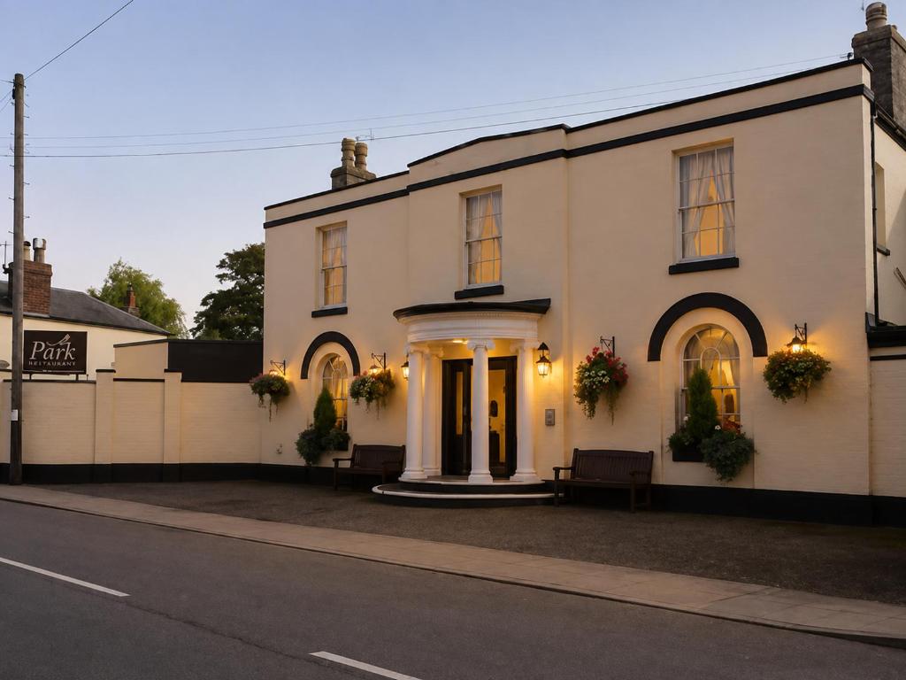 a white building with flowers on the front at The Park Hotel - Sure Hotel Collection by Best Western in Diss