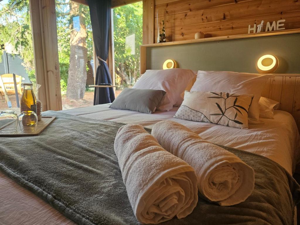 a bedroom with two beds with towels on them at L'Escapade du Puy in Saint-Amand-sur-Sèvre