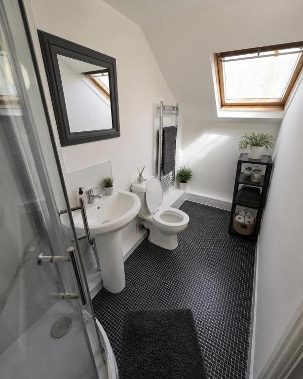 a bathroom with a toilet and a sink at Northenden Stayzzz in Manchester