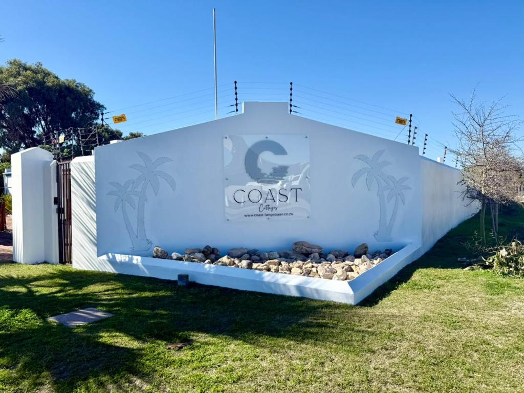a large sign for a coast aquarium in a yard at Coast Cottages Langebaan in Langebaan