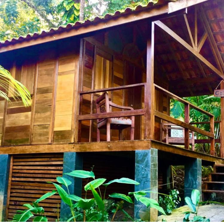 a building with a balcony with a chair on it at Pousada Recanto Afetivo in Trindade
