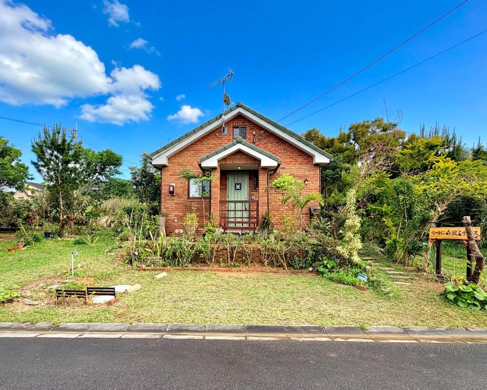a brick house on the side of a road at 今帰仁森風テラス in Nakijin