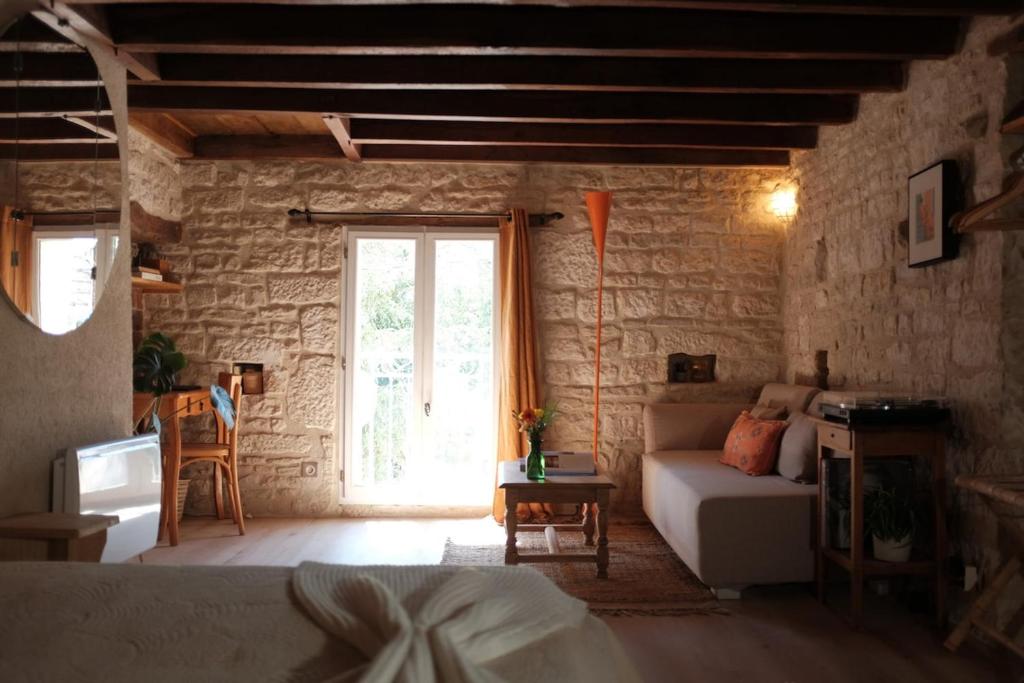 a bedroom with a bed and a large window at Maisons Vaudésir - Lyla, Chablis in Chablis