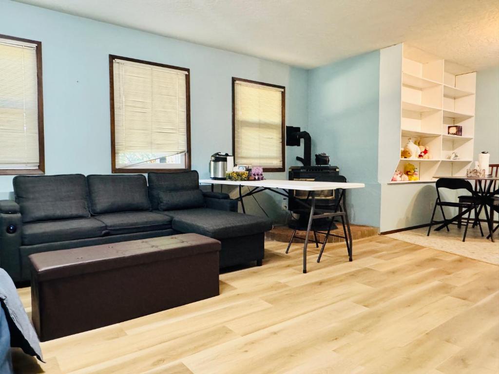 a living room with a black couch and a table at Zoe house in Victoria