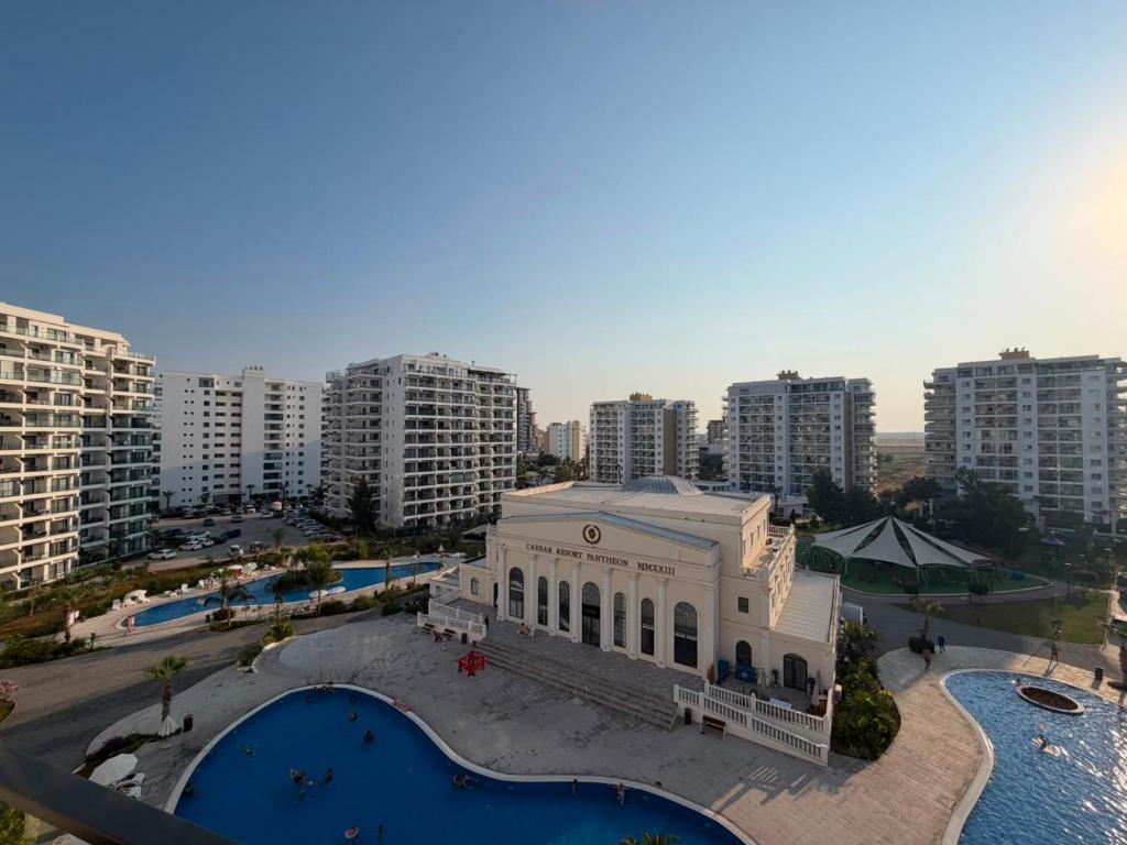 an aerial view of a building in a city with buildings at Caesar Resort & SPA - Apartments Studio in Iskele