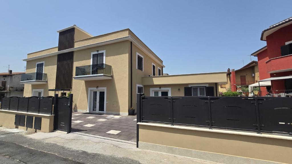 a house with a black fence in front of it at Dimora Clorinda 2 in Passo Corese