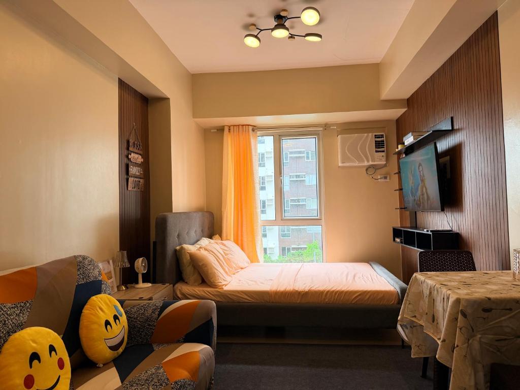 a small room with a bed and a window at Avida Condo Lux Studio Unit in Iloilo City