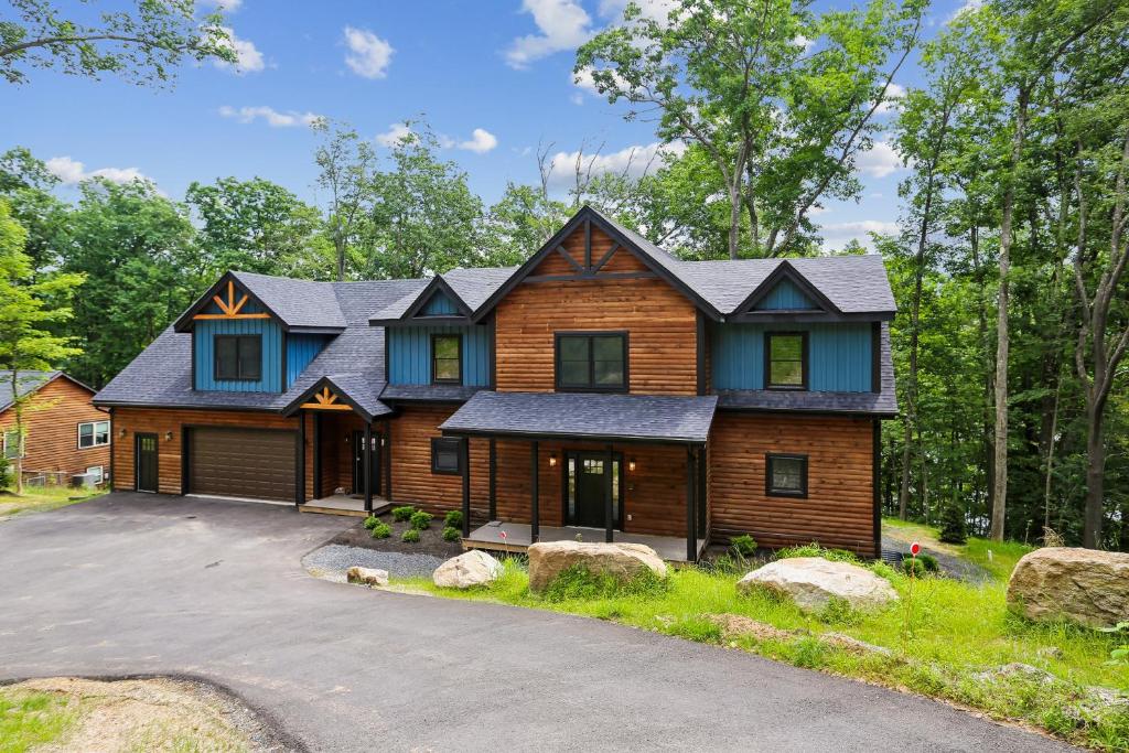 a log home with a gambrel roof at Lakefront Private Indoor Pool New in Mountain Lake Park