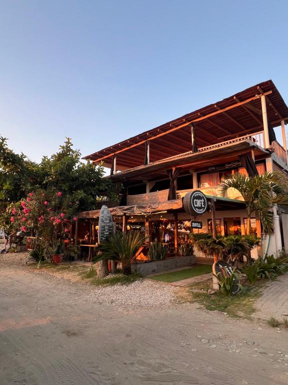 a building with a restaurant on the side of a street at Aloha.ayampe in Ayampe