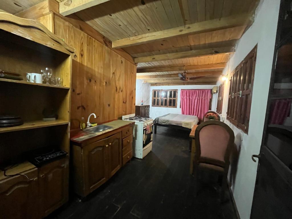 a kitchen with a sink and a room with a bed at Puerto Las marias in Candelaria