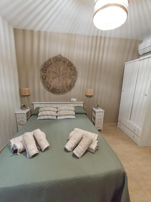 a bedroom with a large bed with towels on it at El DESAFÍO in Riópar