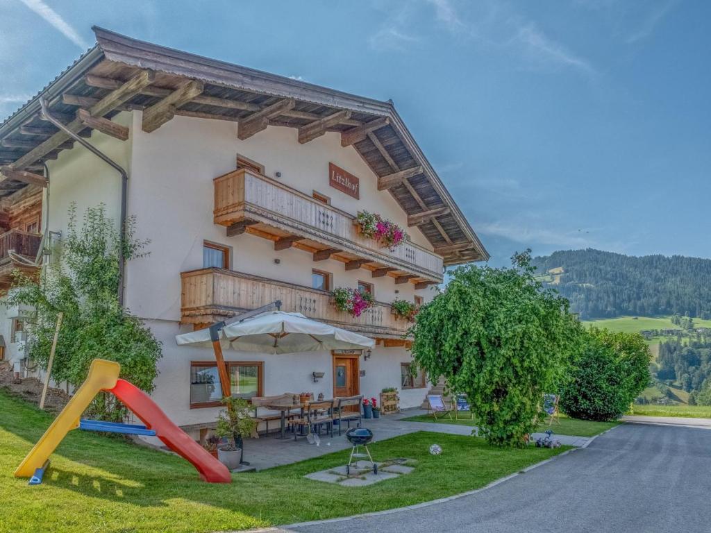 a house with a playground in front of it at Kraftplatz am Litzlhof in Itter