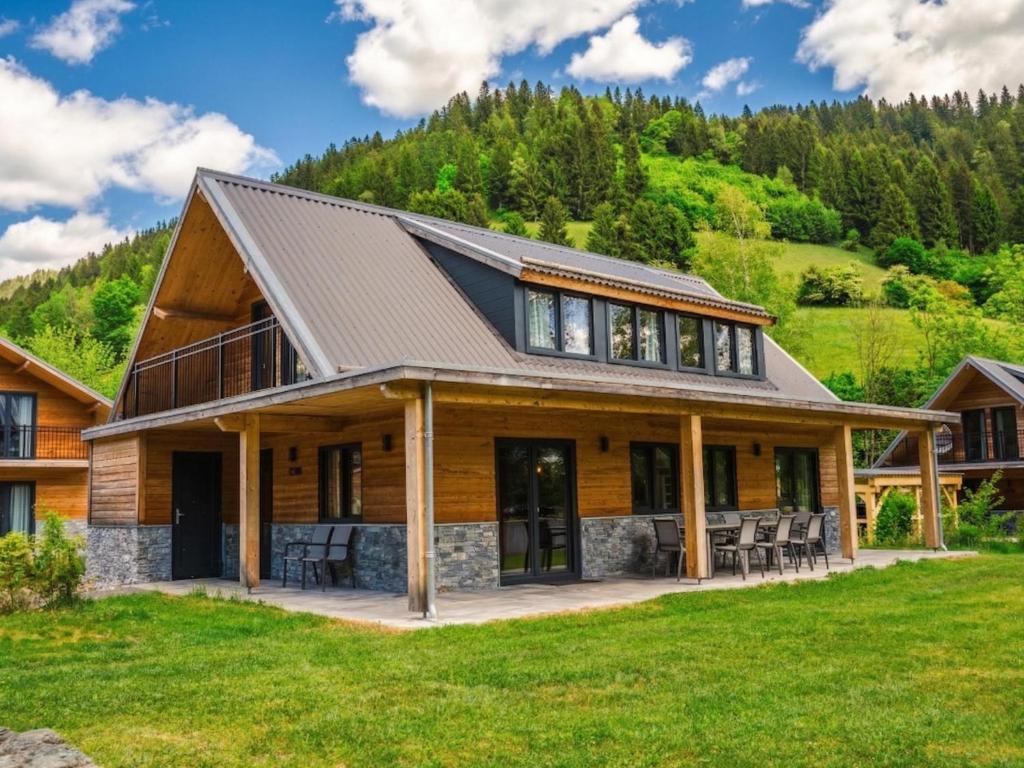 a large house with a roof of wood at Afritz am See in Afritz