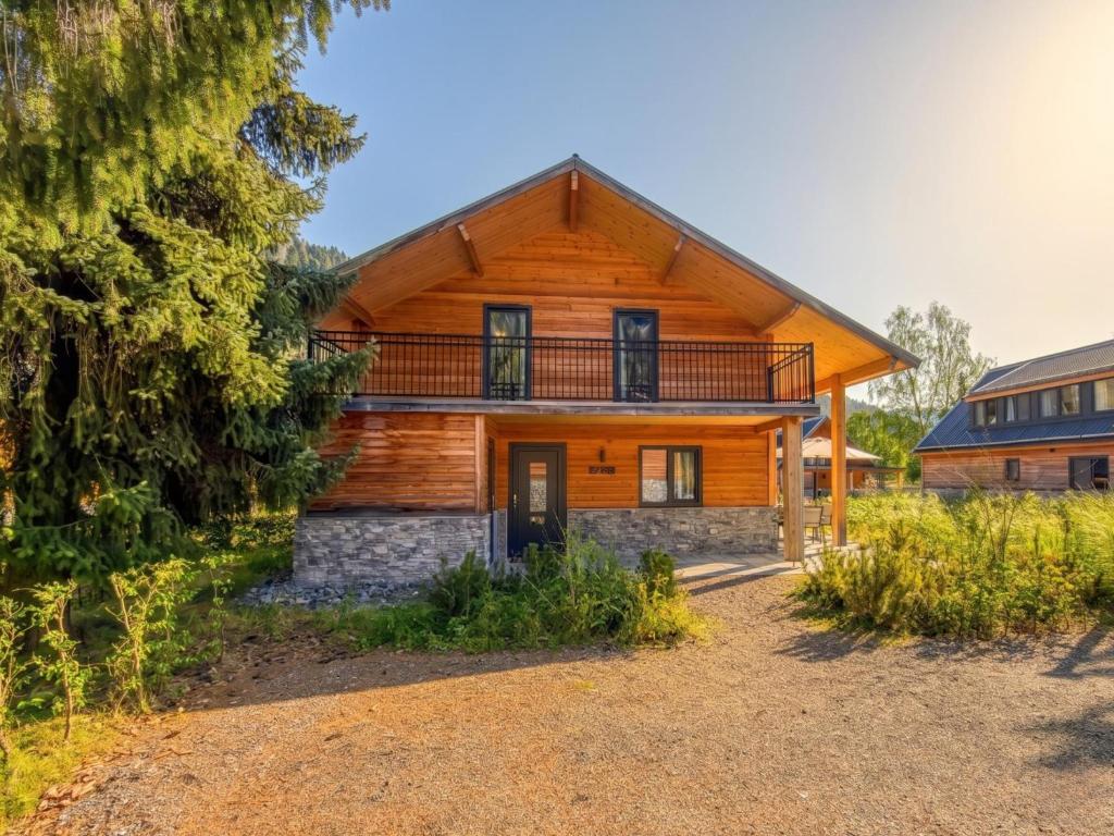 a log home with a porch and a balcony at Seechalet Afritz in Afritz