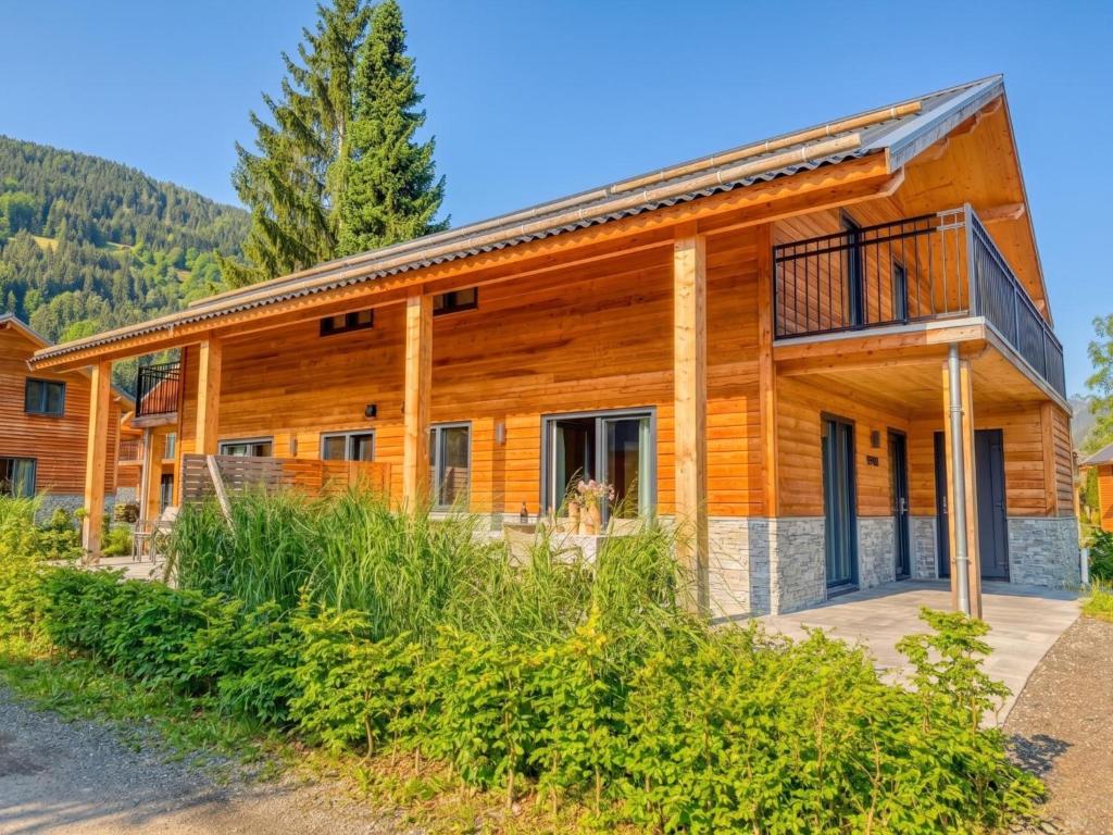 a log home with a deck and a balcony at Berg und See in Afritz
