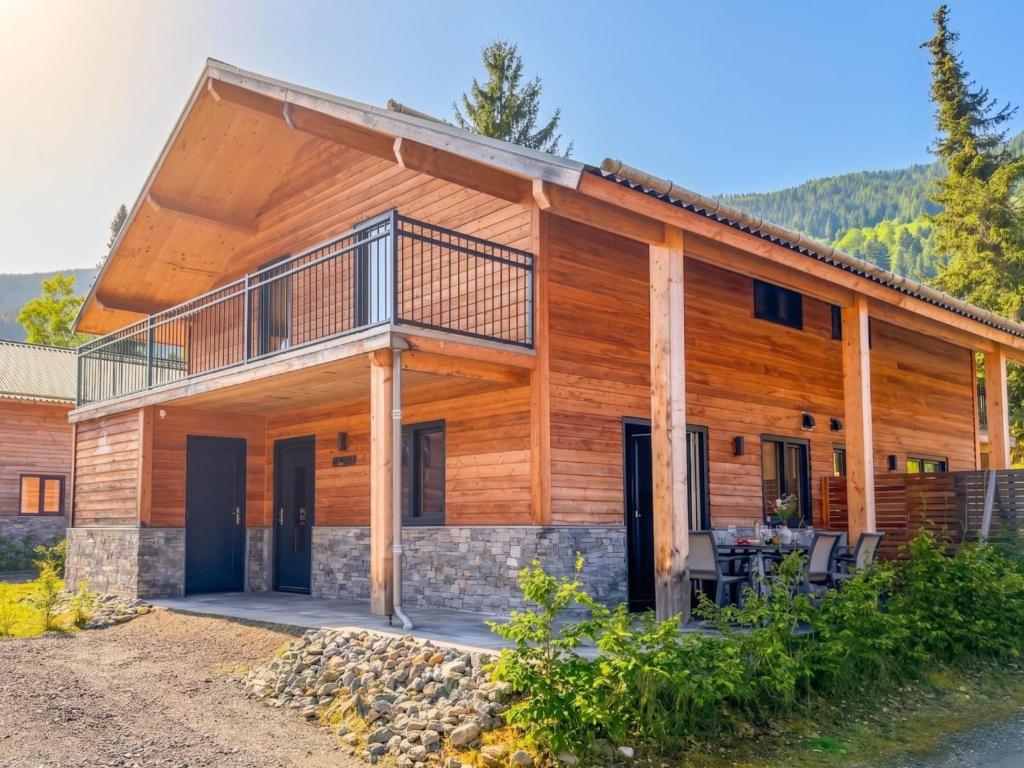 a large wooden house with a balcony at Mirnockblick in Afritz