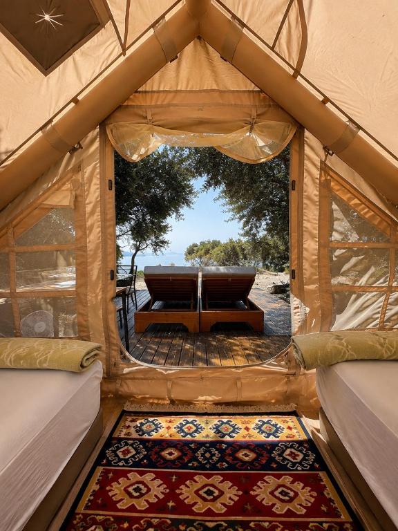 a inside of a tent with a table and a rug at Cimarte The Path Lukove in Lukovë