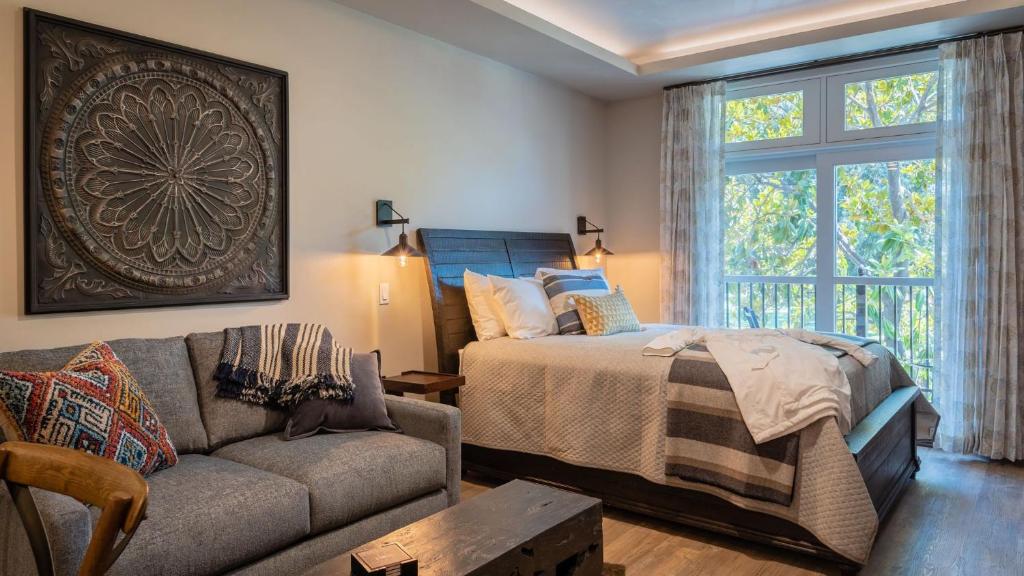 a living room with a bed and a couch at Paso Park Suites by AvantStay in Paso Robles