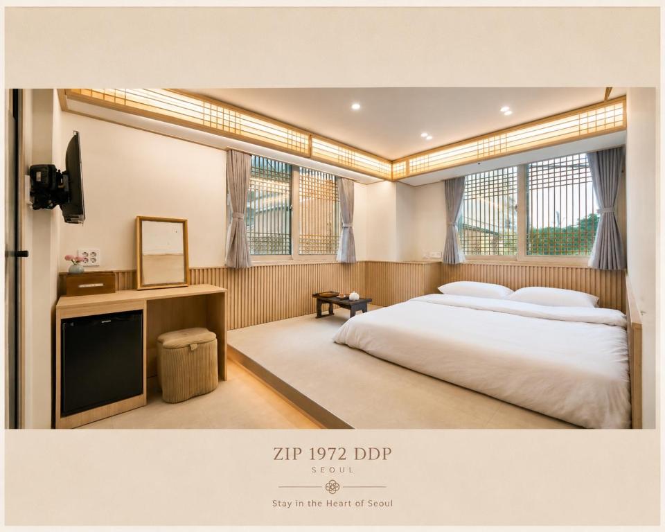 a bedroom with a large bed and a television at ZIP 1972 DDP two-min from airport bus station 4-min from DDP subway station in Seoul