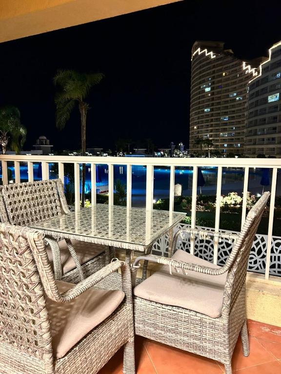 a table and chairs on a balcony with the ocean at Nashwa m mohamed in Ain Sokhna