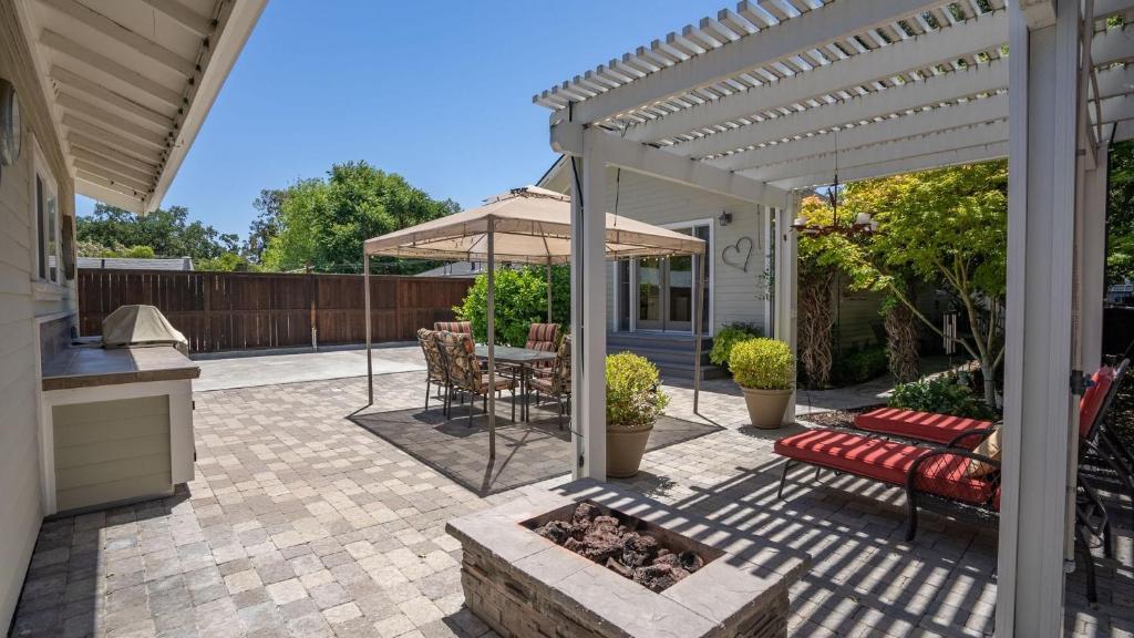a patio with a fire pit and an umbrella at 13th Street Retreat by AvantStay in Paso Robles