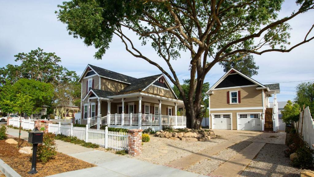 a house with a white fence and a tree at Baby Bliss by AvantStay in Paso Robles