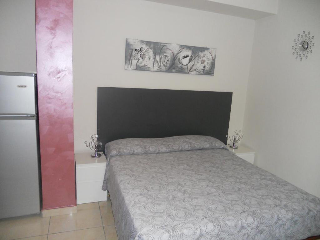 Postel nebo postele na pokoji v ubytování B&B Le Tre Gemme Junior