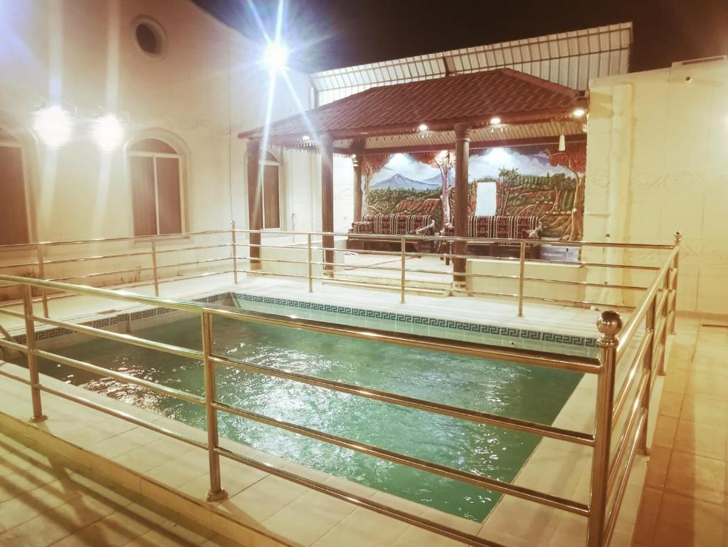 a pool of water in a room with a building at استراحه الصفا in Medina
