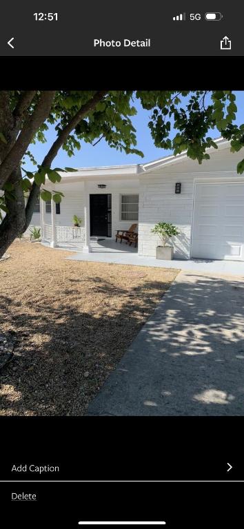 a picture of a white house with a porch at Boho Chic in New Port Richey
