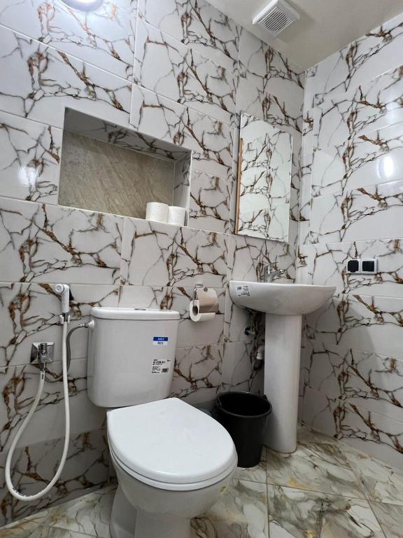 a bathroom with a toilet and a sink at Oberg imsouane in Imsouane