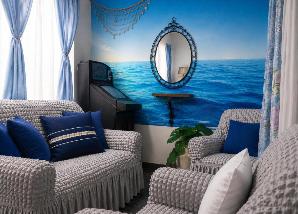a living room with two chairs and a mirror at Mistela Altos Crucero Boutique - Alojamiento temático - Zona Residencial Ciudad - Viajes al Aeropuerto - in Godoy Cruz