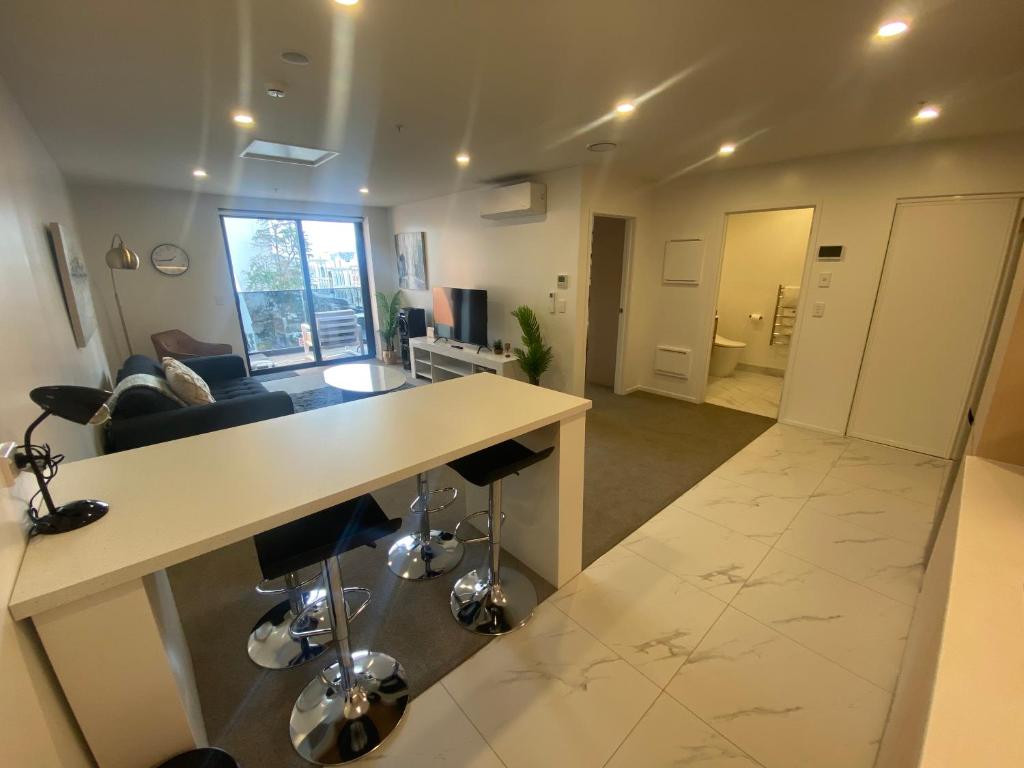 a large living room with a table and chairs at Central City Views In Heart of Central Chch by Stadium in Christchurch
