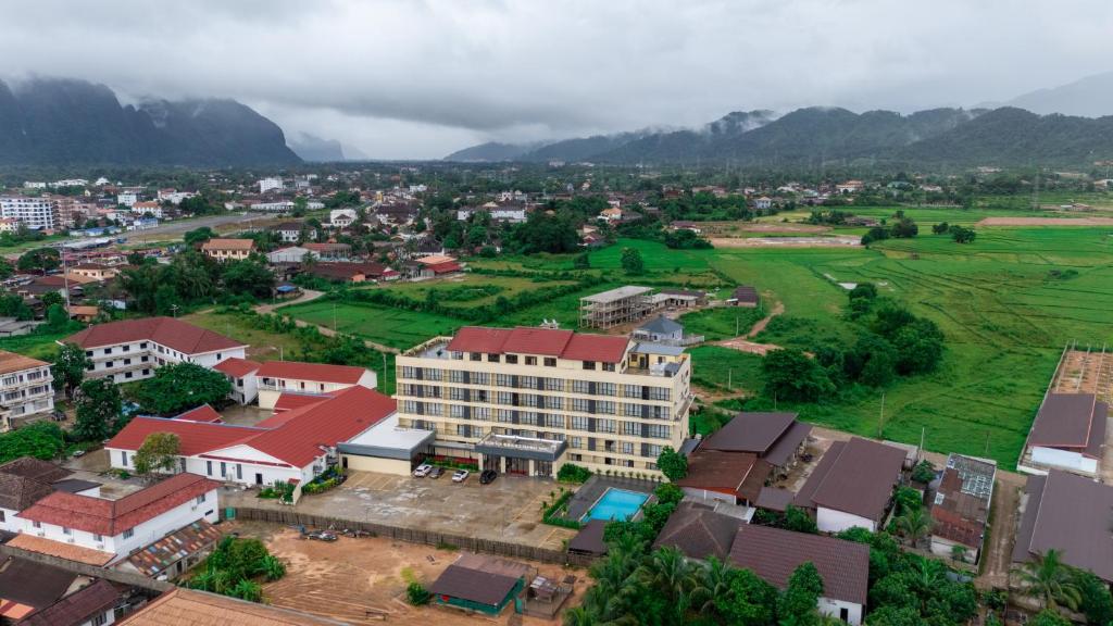 an aerial view of a city with mountains in the background at vangvieng THAVIKUN HOTEL in Vang Vieng