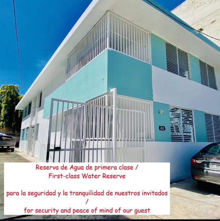 a white and blue building with a sign in front of it at Star of the Olympus 1b Family Suite at Miramar Puerto Rico near beaches and Convention Center in San Juan