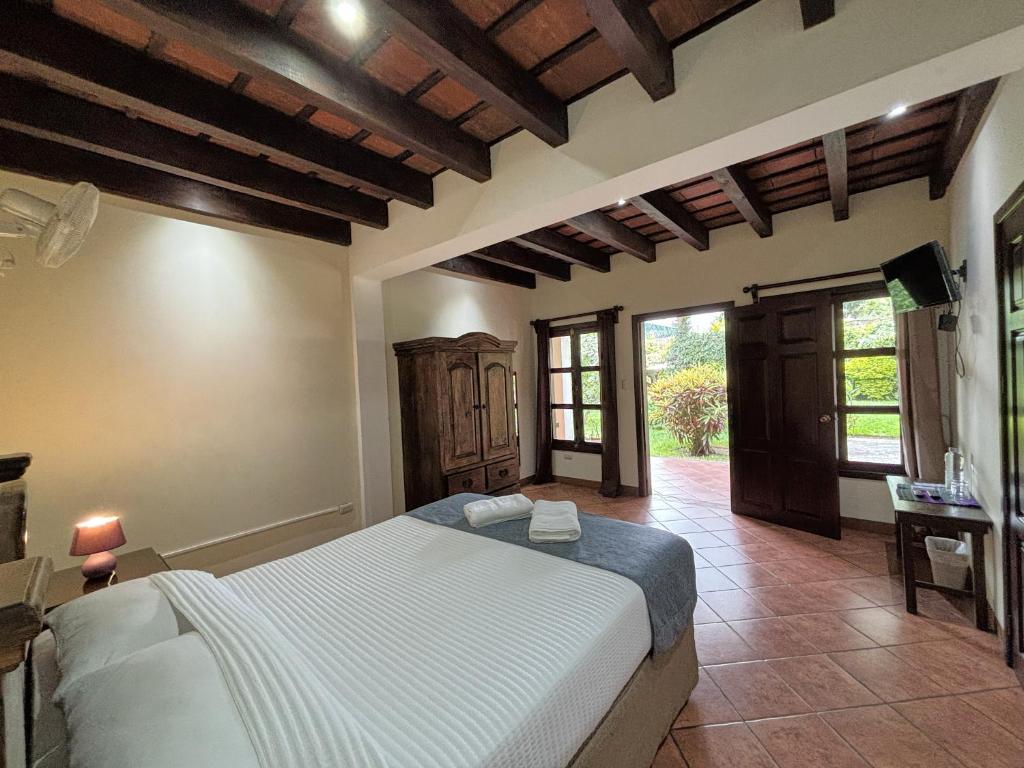 a bedroom with a large bed in a room at Alana Hotel By ISH in Antigua Guatemala