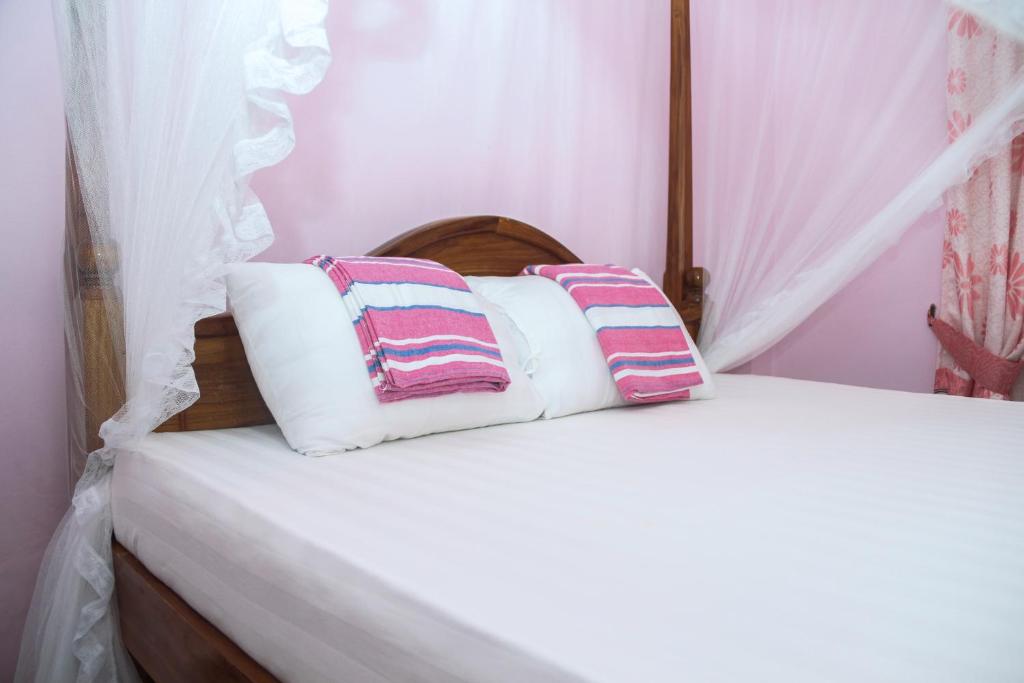 a bedroom with a bed with two pillows on it at veranda guest home in Mirissa