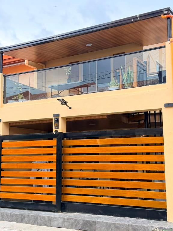 a house with a wooden gate in front of it at Casa De Jumeirah in Bacolod