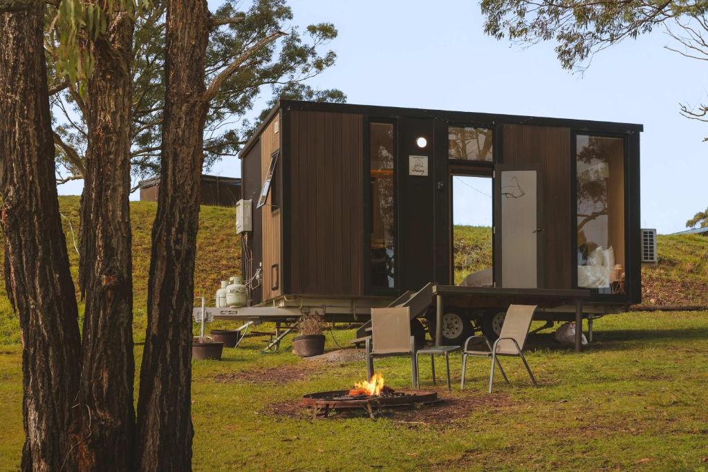 a tiny house with a fire in the yard at One Gaea by Tiny Away in Rainbow Flat