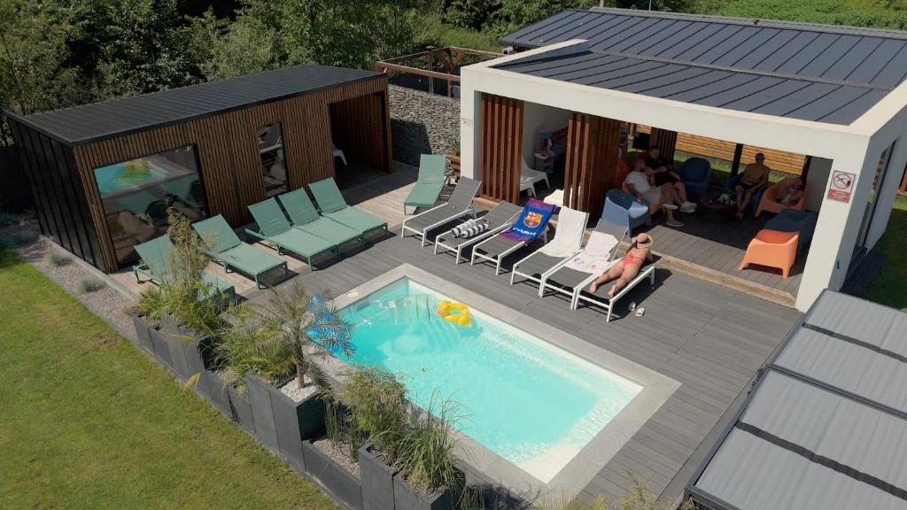 an overhead view of a house with a swimming pool at Leśna Polana Domki in Okuninka