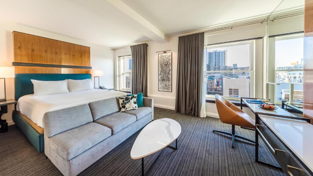 a hotel room with a bed and a couch at Andaz San Diego, By Hyatt in San Diego