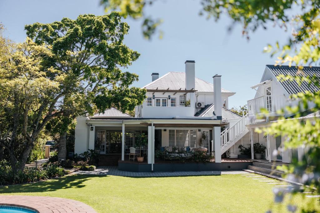 an exterior view of a white house with a yard at Whispering Oaks Guest House in George