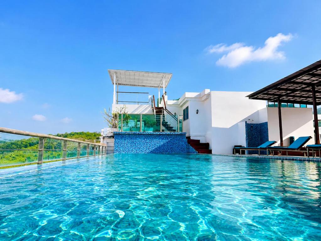 a swimming pool at a villa with blue water at Aspery Hotel in Patong Beach