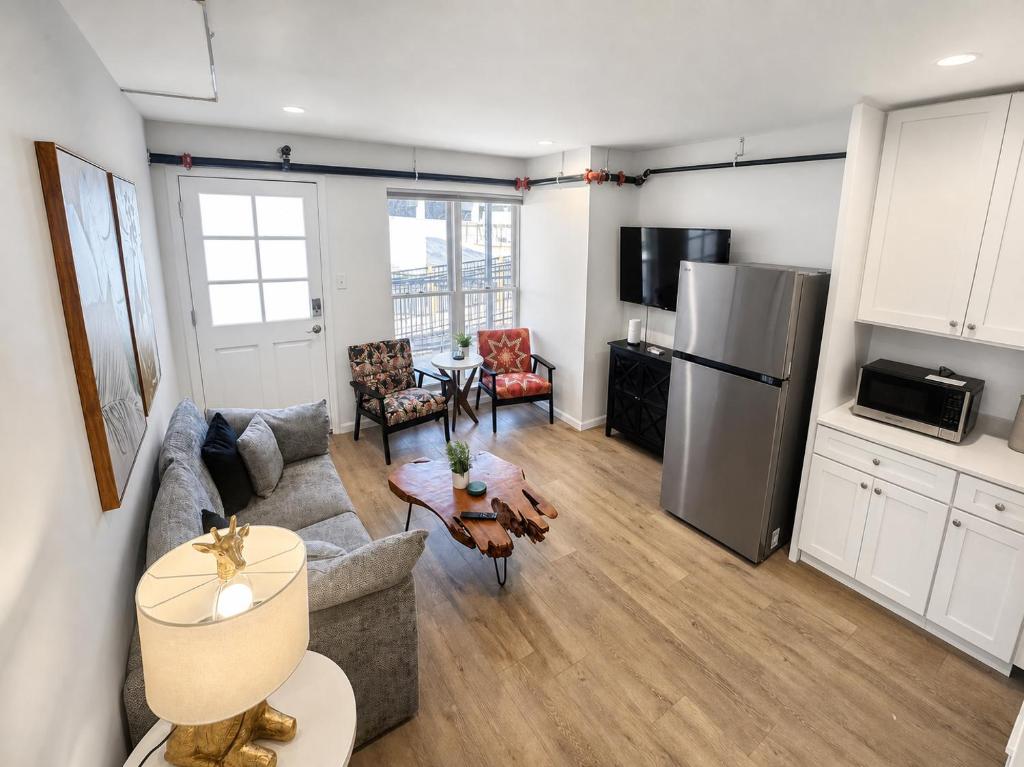 a living room with a couch and a table at Stylish 2BR Retreat - Concrete & Canopy in St. Charles