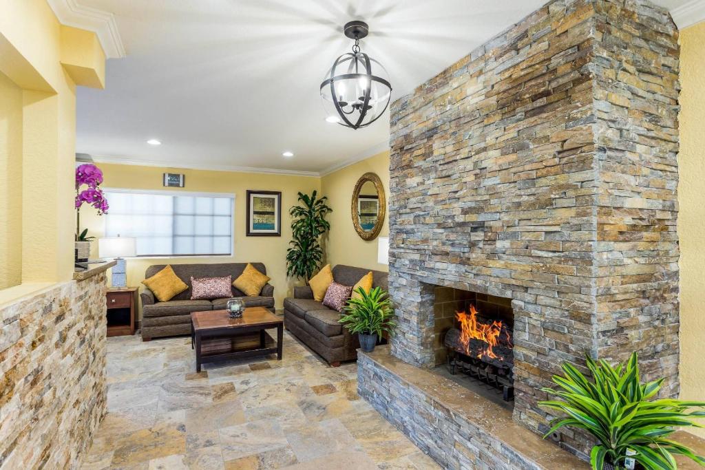 a living room with a large stone fireplace at Quality Inn Escondido San Diego North County in Escondido