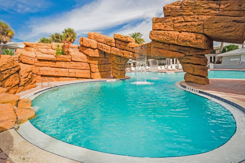 a swimming pool in a resort with a rock wall at Radisson Resort at the Port in Cape Canaveral