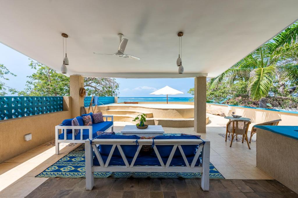 a living room with a view of the ocean at Tequila Sunrise Sky Cabana-Diani Beach in Diani Beach