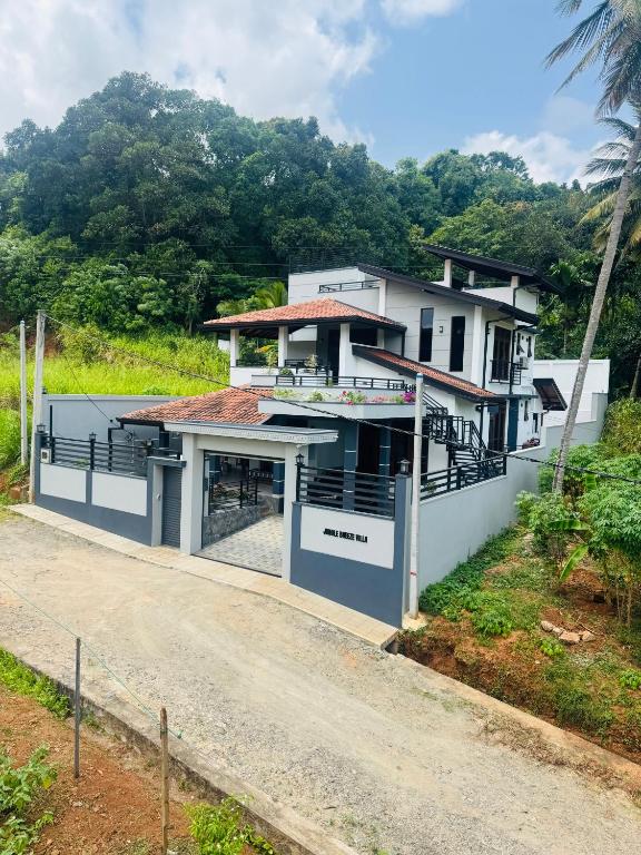 a house on the side of a road at Jungle Breeze Villa in Melsiripura